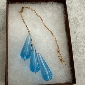 Add a little color to your look with this three blue tear drop glass necklace